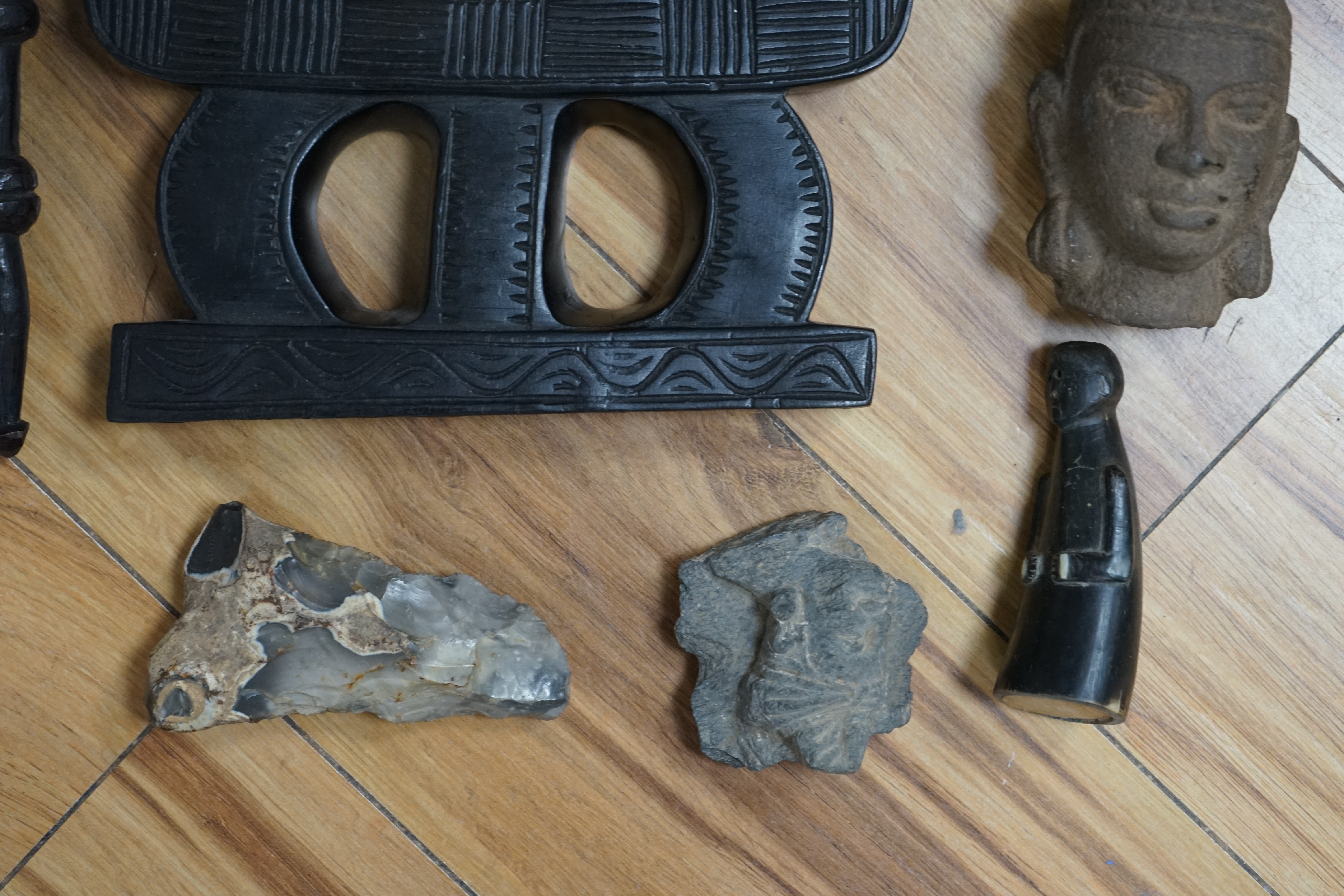 A flint axe, an inuit horn carving, a South American tribal stone head, a malachite panel, another stone carving and Chinese stand, largest 32cm. Condition - varies